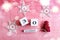 Calendar for December 30: cubes with number 30, name of the month in English, decorative snowflakes and a Christmas tree on a pink