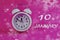 Calendar for January 10: a light alarm clock on a pastel background, the numbers 10, the name of the month January in English,