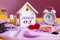 Calendar for January 2: decorative house with the name of the month in English, number 02, various cosmetics, white alarm clock,