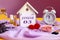 Calendar for January 3: decorative house with the name of the month in English, number 03, various cosmetics, white alarm clock,