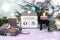 Calendar for January 5: name of the month in English, numbers 0 and 5, burning candles, a gift tied with a purple ribbon, a