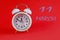 Calendar for March 11: a white alarm clock on a crimson background close-up, the numbers 11, the name of the month of March in