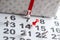 Calendar with numbers marked with white and red push pins. The number of February 14. Background for Valentine`s Day