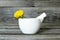 Calendula flower in a mortar on wooden background