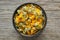 Calendula flowers. Bowl of dry marigold petals on wooden board. Top view. Herbal medicine