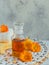 Calendula products. Bottle of cosmetic or essential oil and fresh calendula flowers on white background. Aromatherapy