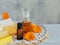 Calendula products. Bottles of cosmetic, aromatic or essential oil and fresh calendula flowers on light background