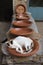 Calico cat sleeping in a ceramic tagine dish