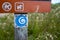 California Coastal Trail logo on sign posting along trailhead path