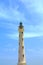 California Lighthouse on blue sky background isolated, Aruba coastline.