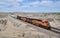 California, Mojave Desert: Three BNSF Locomotives, One CSX Locomotive Pull Long Freight Train