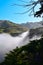 California Ragged Point Mountain with God Rays Piercing through the Morning Fog