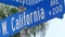 California street road sign on crossroad. Lettering on intersection signpost, symbol of summertime travel and vacations. USA