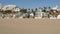 California summertime beach aesthetic, sunny blue sky, sand and many different beachfront weekend houses. Seafront