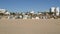 California summertime beach aesthetic, sunny blue sky, sand and many different beachfront weekend houses. Seafront