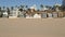 California summertime beach aesthetic, sunny blue sky, sand and many different beachfront weekend houses. Seafront buildings, real