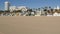 California summertime beach aesthetic, sunny blue sky, sand and many different beachfront weekend houses. Seafront buildings, real