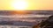 California sunset surf waves on beach rocks 4K