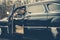 Call boy in vintage auto. Bearded man in car. Retro collection car and auto repair by mechanic driver. Travel and