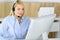 Call center. Blonde business woman sitting in headset at customer service office. Concept of telesales business or home
