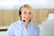 Call center. Blonde business woman sitting in headset at customer service office. Concept of telesales business or home