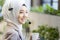 Call center drinking warm water and rest. Muslim call center staff. Young female customer support executive working in office