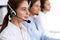 Call center. Group of operators at work. Focus at beautiful business woman in headset