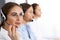 Call center. Group of operators at work. Focus at beautiful business woman in headset