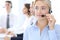 Call center. Group of operators at work. Focus at blonde business woman in headset