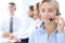 Call center. Group of operators at work. Focus at blonde business woman in headset