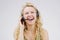 Call center, woman and laugh in studio portrait with headset, smile and excited for tech support by backdrop. Funny