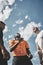 Call it. Low angle shot a referee flipping a coin among two rugby team captains to see who will start the kickoff of the