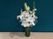 Calla lily in a jar on the table, isolated on petrol color