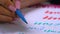 Calligrapher student practices in writing word beauty with blue marker on canvas. Creative artist freelancer working on