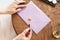 A calligrapher woman makes a wax seal on the envelope. Close-up. Soft focus.