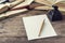 Calligraphy dip pen and white paper on wooden table with books