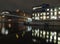 calls landing on the river aire in leeds at night with the lights of historic old buildings and apartments reflected in the water