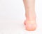 Callus on the heel of the girl`s leg, sealed with a healing plaster to restore the skin, rubbing with close shoes, white