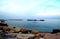 Calm Adriatic sea surrounded by massive rocks under the light blue sky in Pedaso