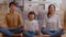 Calm asian family doing yoga meditation concentrate of deep breath at home.Peaceful young parent exercise breathing together for