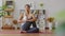 Calm of attractive asian woman practice yoga seated twist pose to meditation in bedroom after wake up in the morning feeling so