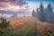 Calm autumn sunrise in Carpathian mountains. Foggy morning view of mountain valley