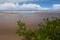 Calm beach of Brazil. The sea and the clouds merge on the horizon