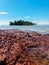 Calm beach scenery with Konet Island or Pulau Konet in Kuala Sungai Baru, Melaka, Malaysia