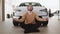 Calm bearded man sitting at lotus pose near new bought car.