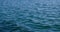 Calm blue ocean surface with gentle waves in summer. Relaxing and peaceful.