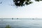 Calm blue sea view with sailboats and ships beyond