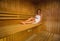 Calm brunette relaxing in a sauna