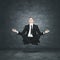 Calm businessman levitating during meditation