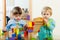 Calm children playing with wooden blocks